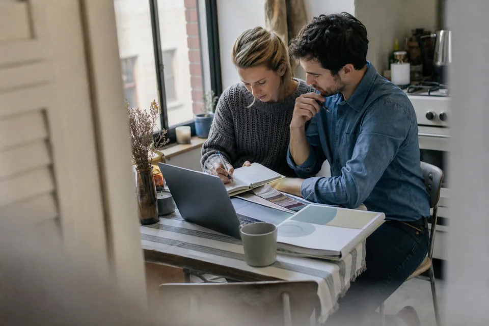Engaged couple taking an online marriage preparation course on a laptop